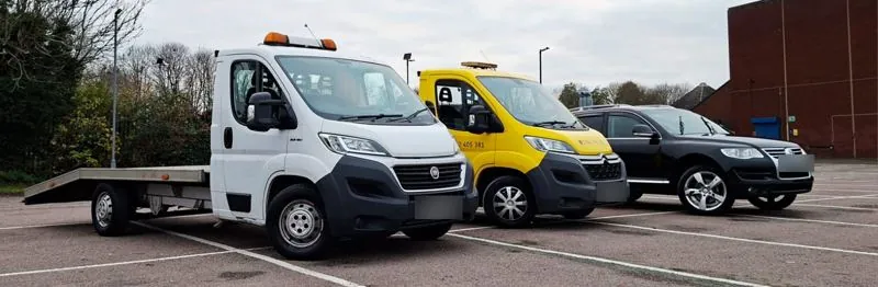 The fleet: white truck, yellow truck and the Touareg
