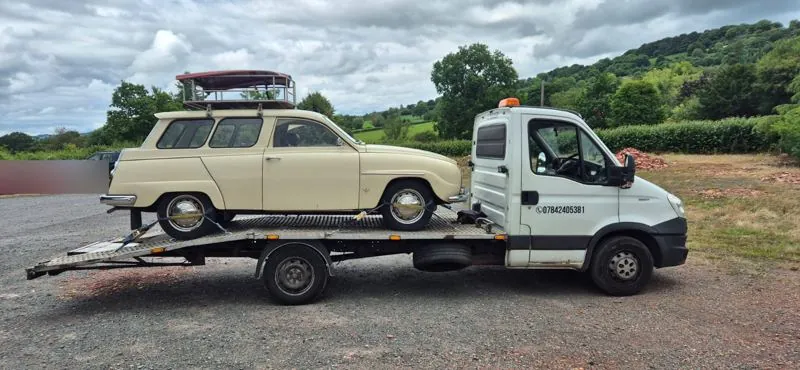 Classic cream Saab estate on the white truck