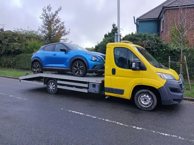 Blue Nissan Juke loaded on VCR's yellow recovery truck