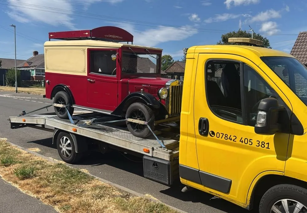 Vit Car Recovery yellow recovery truck carrying a vintage red and cream van